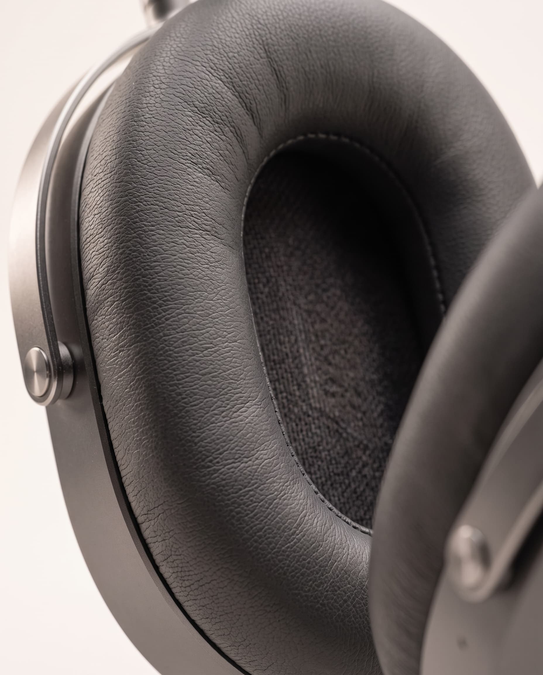 Close-up of a plush charcoal ear cushion with fine stitching
