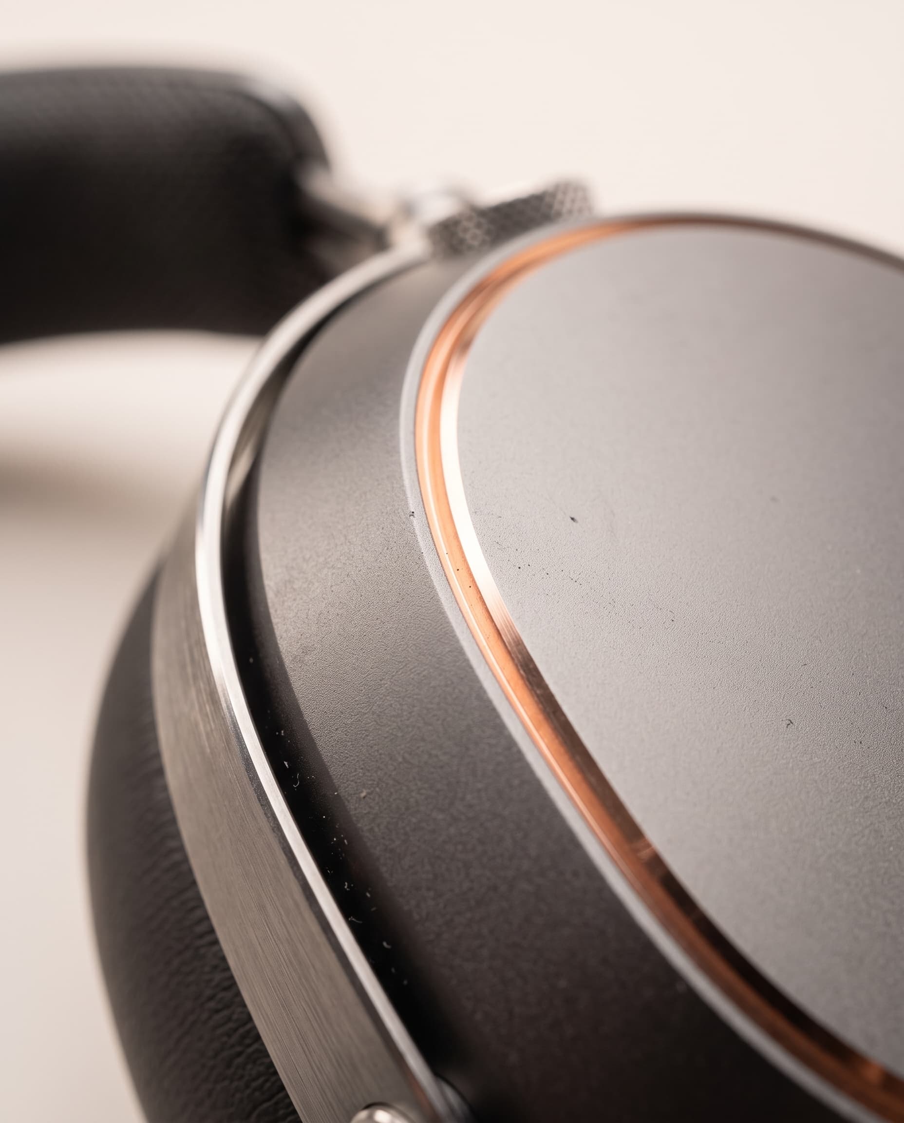 Macro view of a graphite aluminum earcup meeting its polished copper chamfer