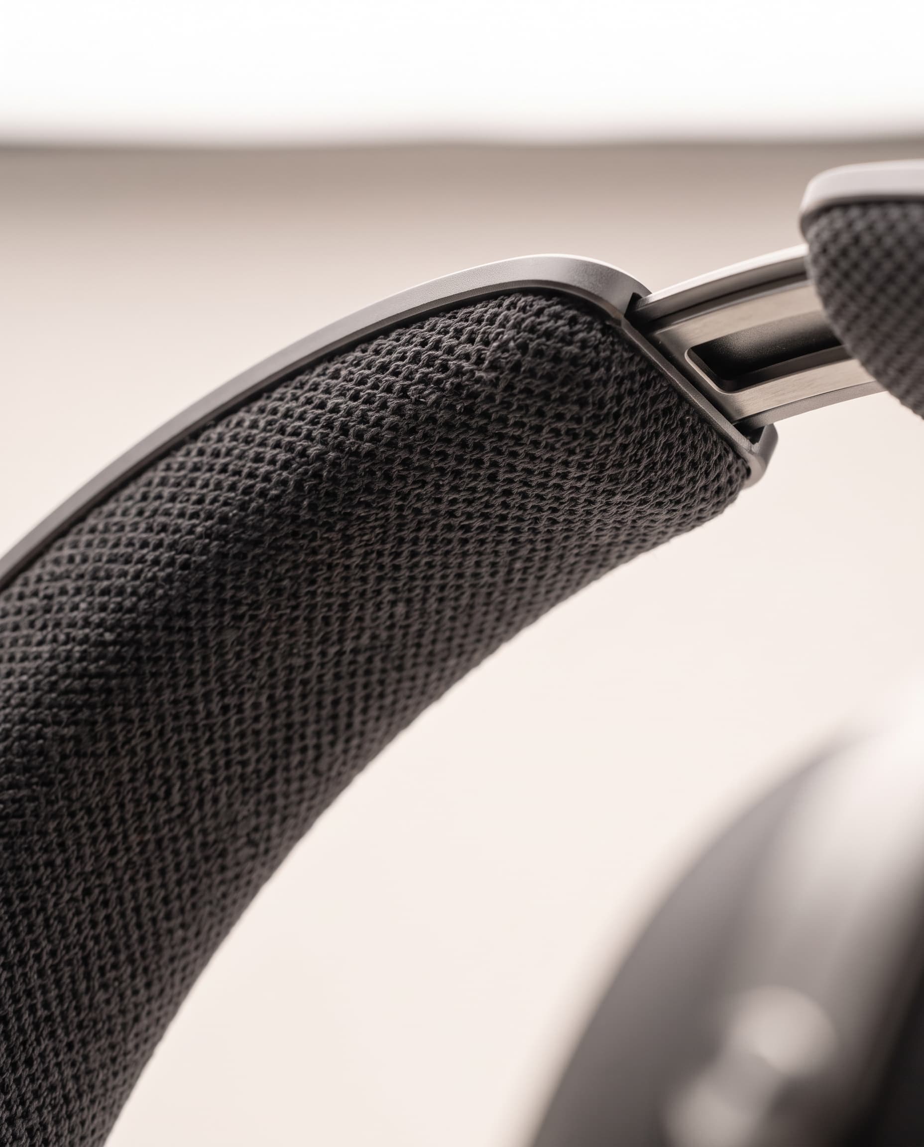 Close-up of the dark knit canopy beneath the aluminum headband