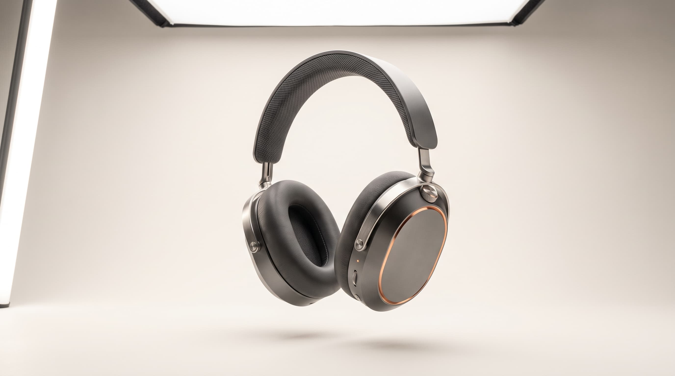 Onde One headphones floating in a photo studio, graphite earcups framed by copper chamfers